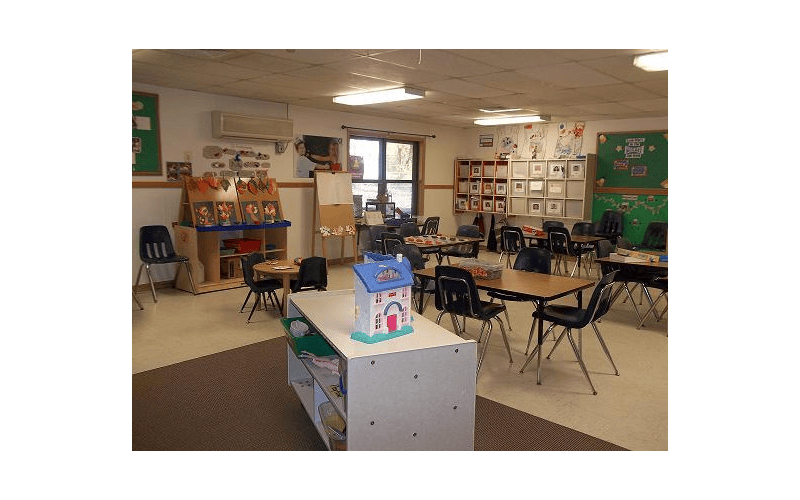 Classroom with small tables, chairs, and learning materials