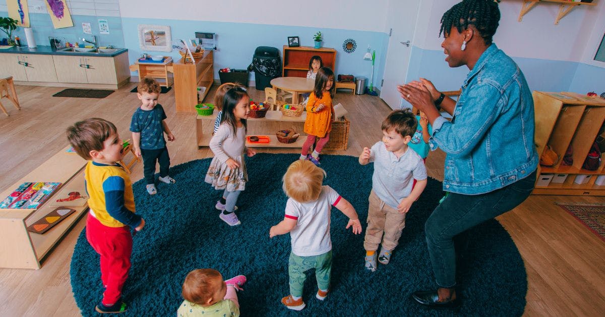 Adult and children playing in a classroom