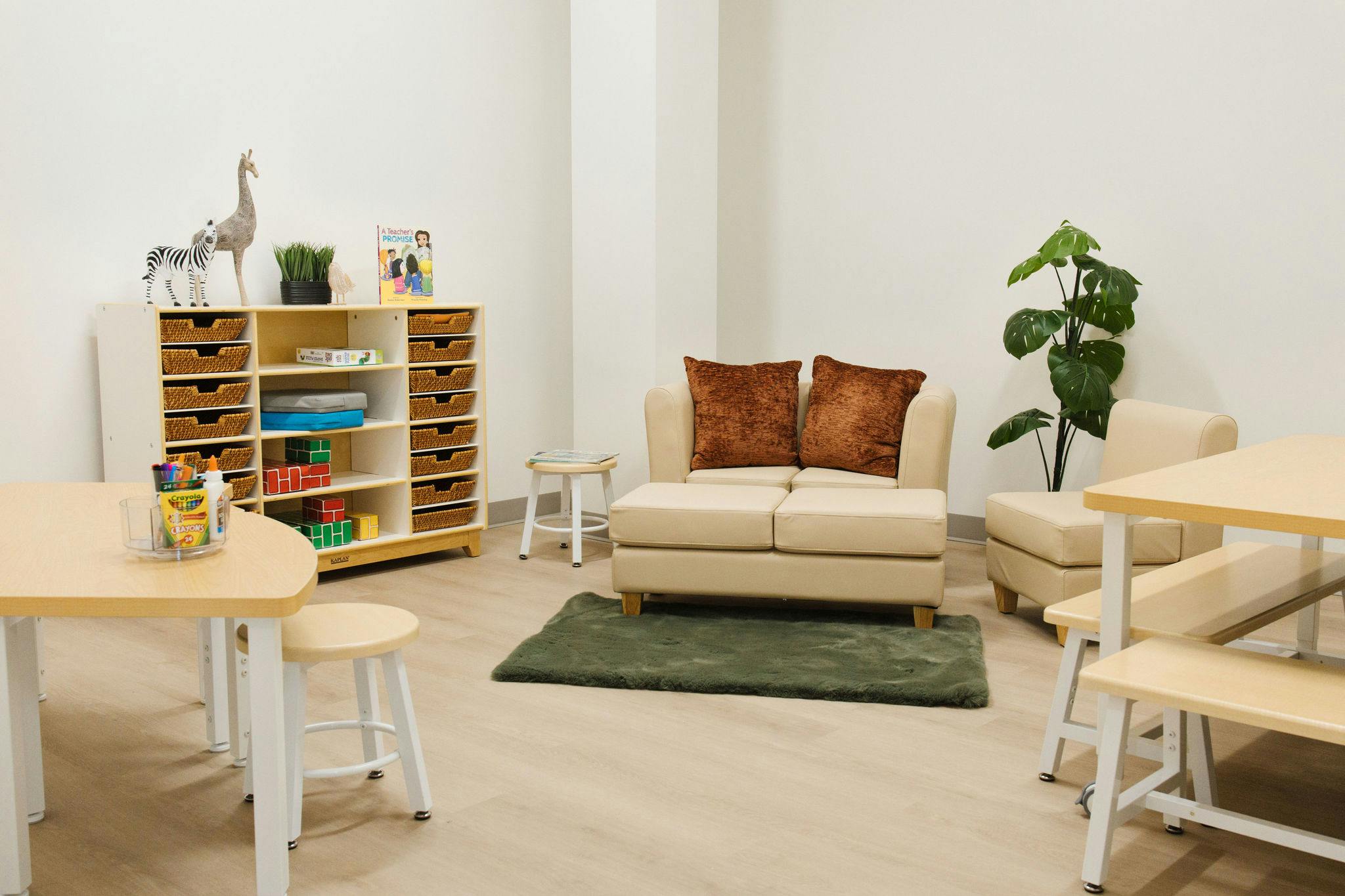 Classroom seating area with a small loveseat and storage shelves
