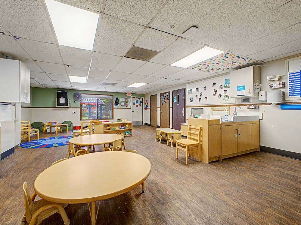 Empty classroom with small tables and chairs