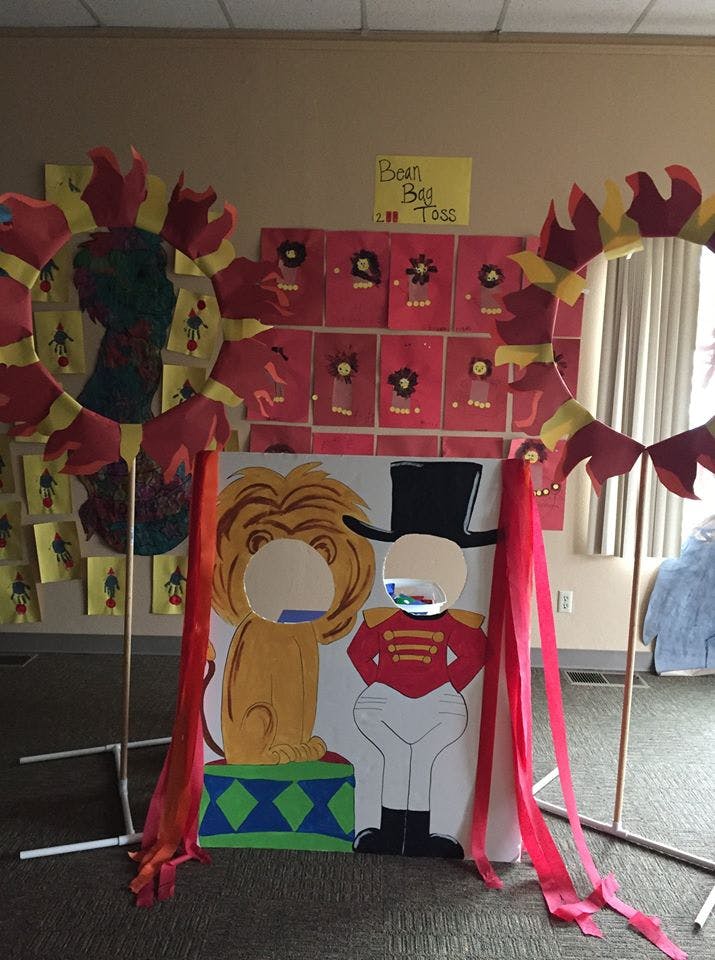 Circus-themed photo booth with lion and ringmaster cutouts