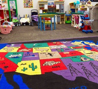 Colorful map rug in a classroom with toys and furniture