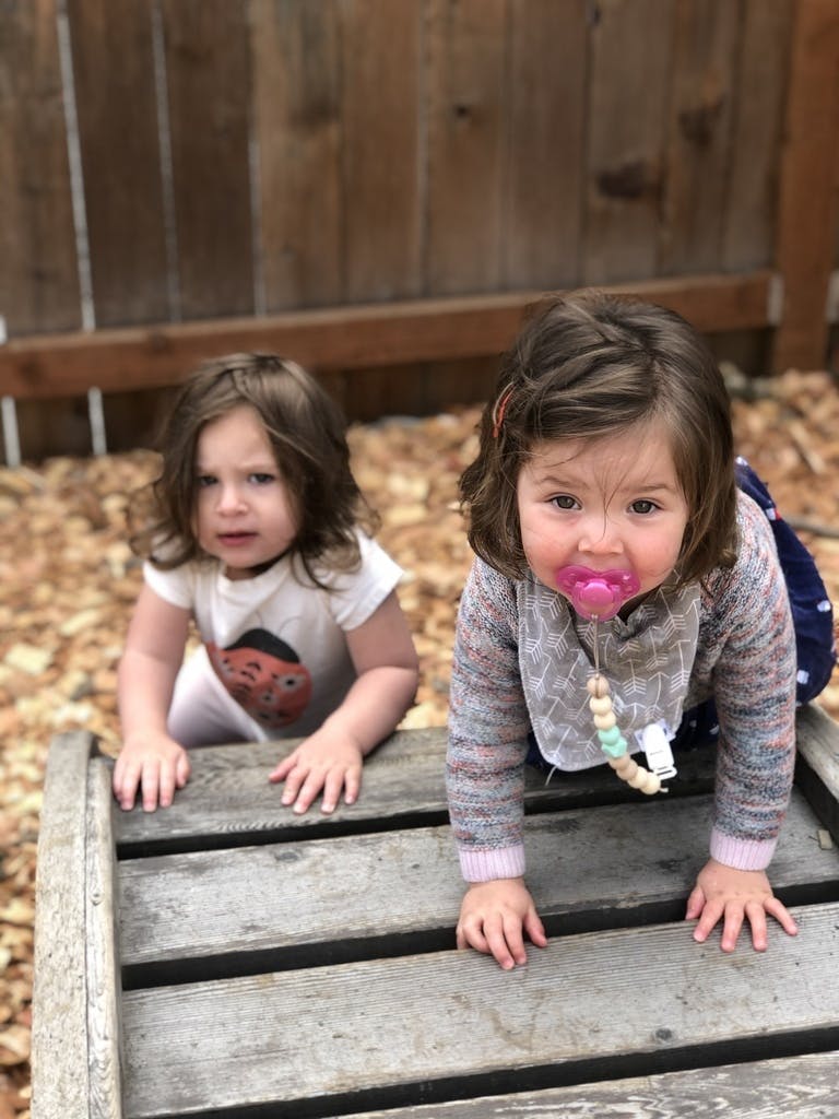 Two children on a wooden structure
