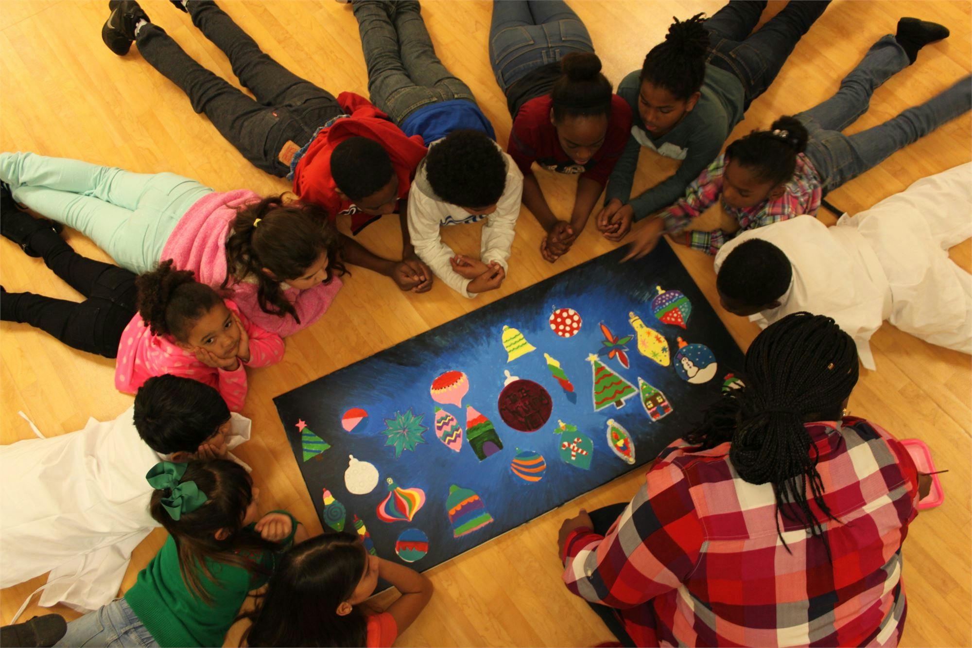 Group of children gathered around a board game on the floor