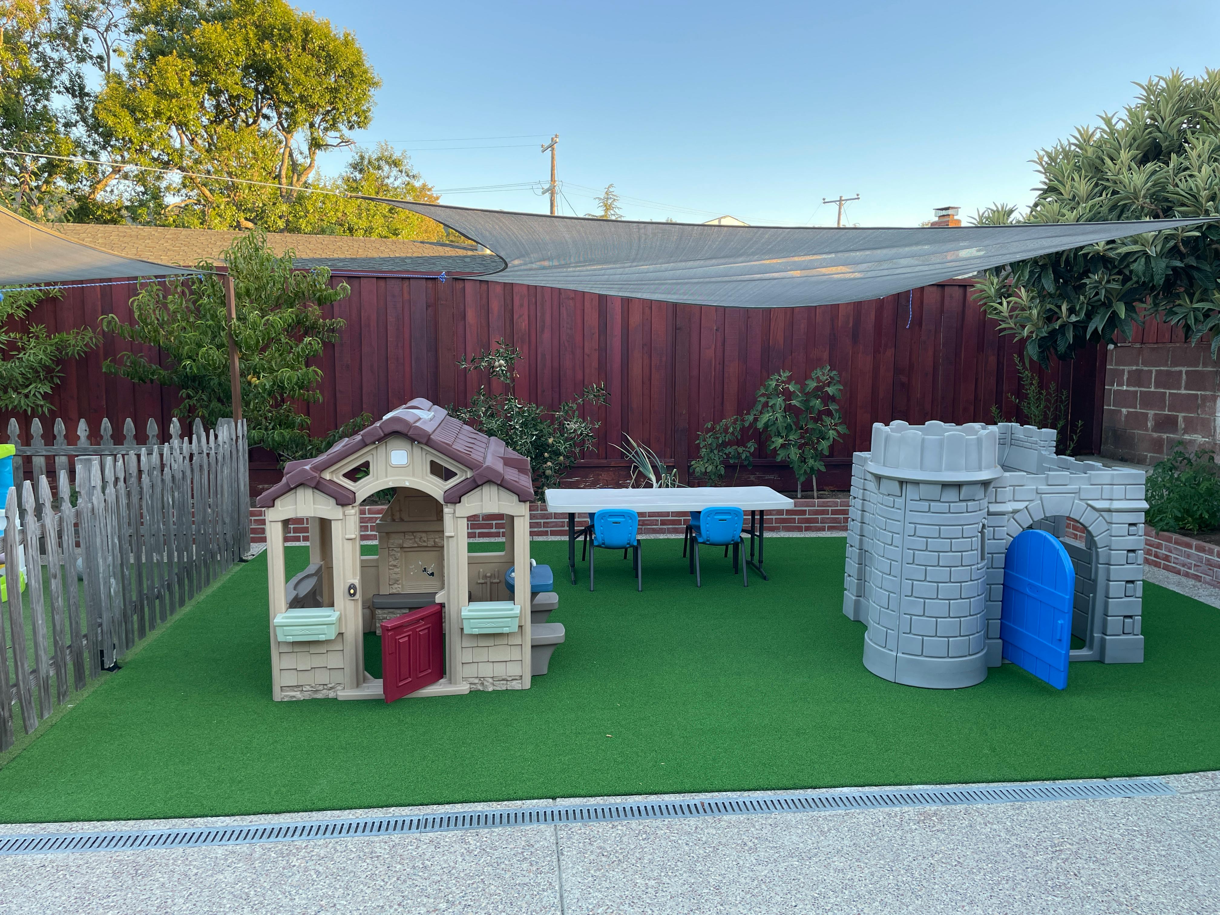 Playhouse and castle play structure on artificial grass