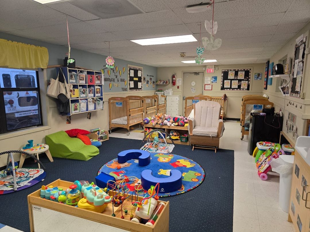 Cribs and play areas in a daycare or nursery classroom