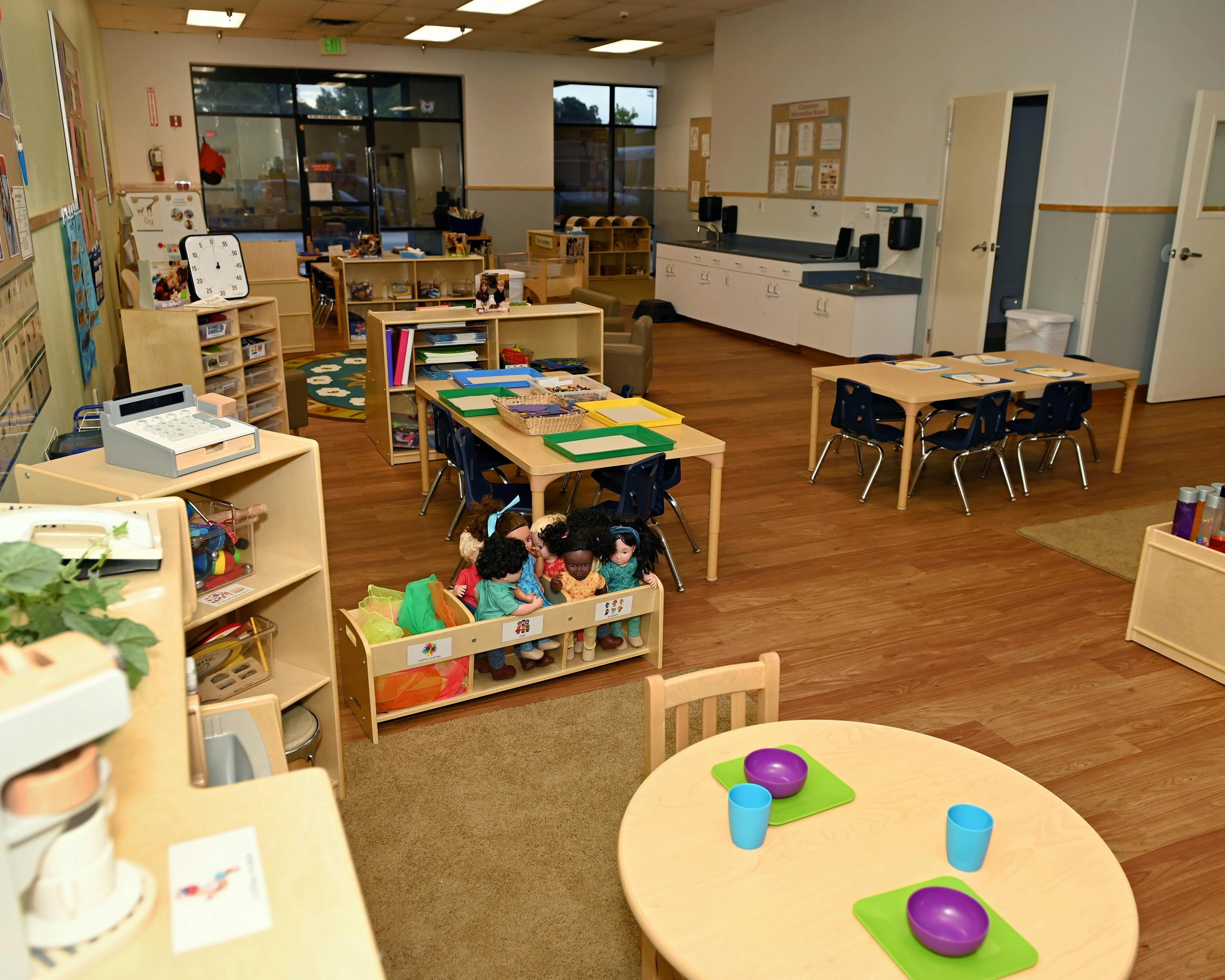 An empty early childhood classroom with multiple activity areas