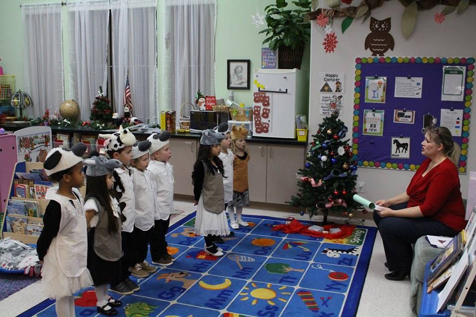 Adult and children in a classroom