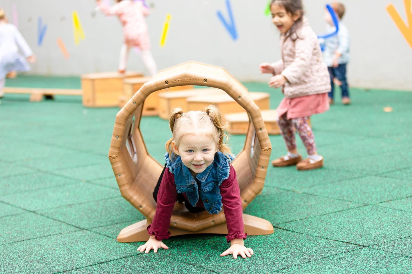Child crawling through a tunnel on a playground