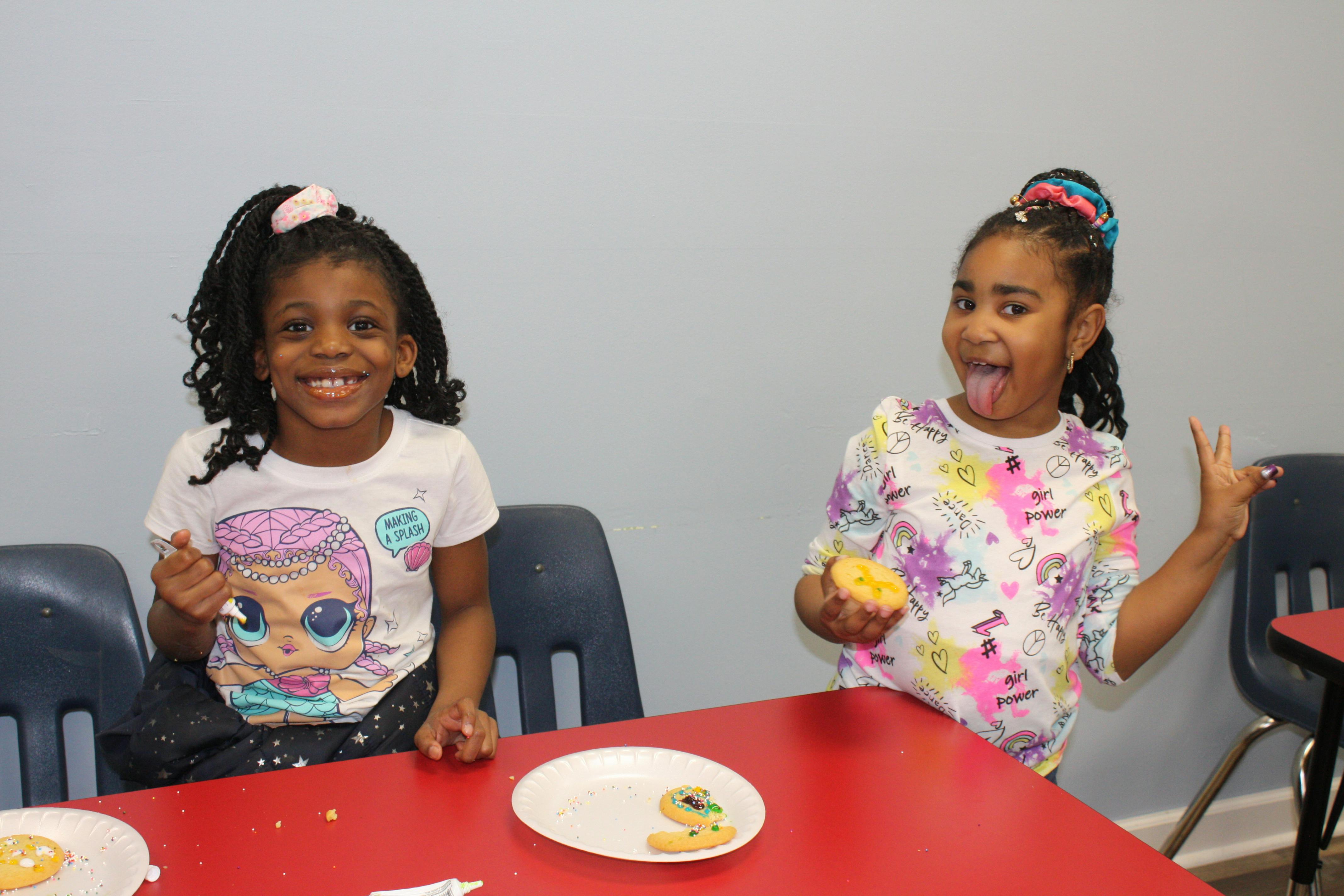 Two children at a table with cookies