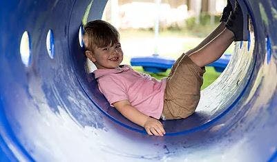 Child in a blue tunnel slide