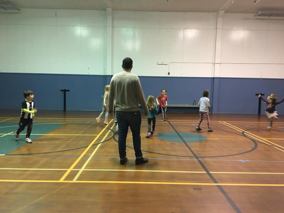 Adult and children playing in a gymnasium