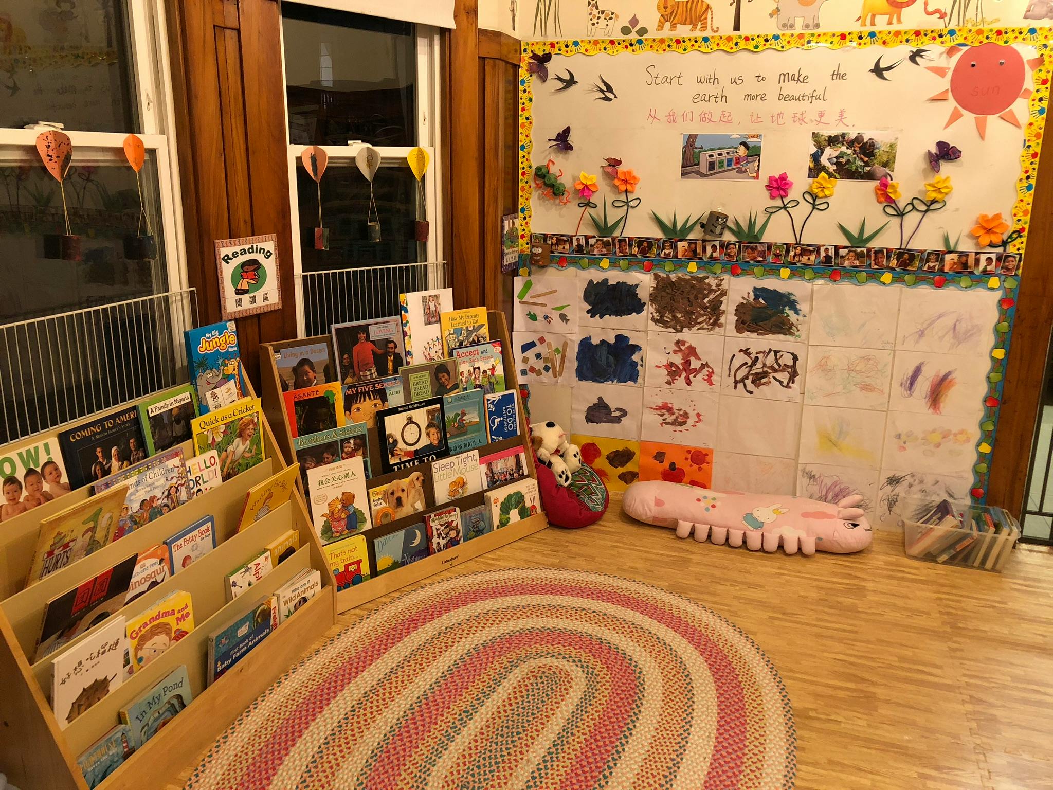 Children's reading nook with bookshelves, rug, and bulletin board