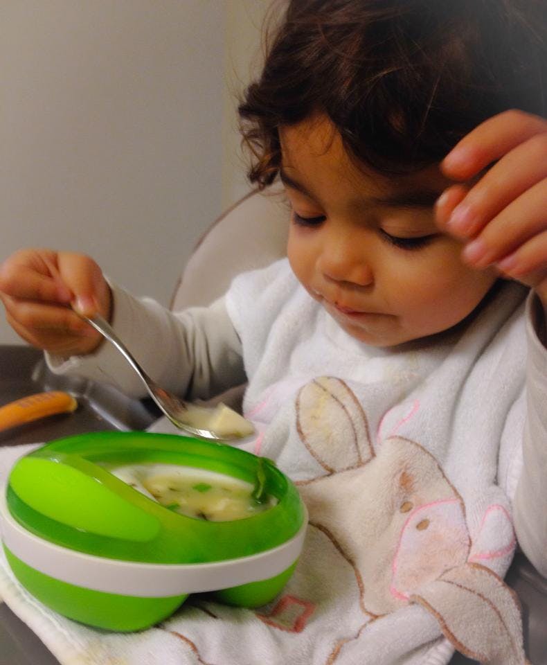 Child eating from a bowl with a spoon