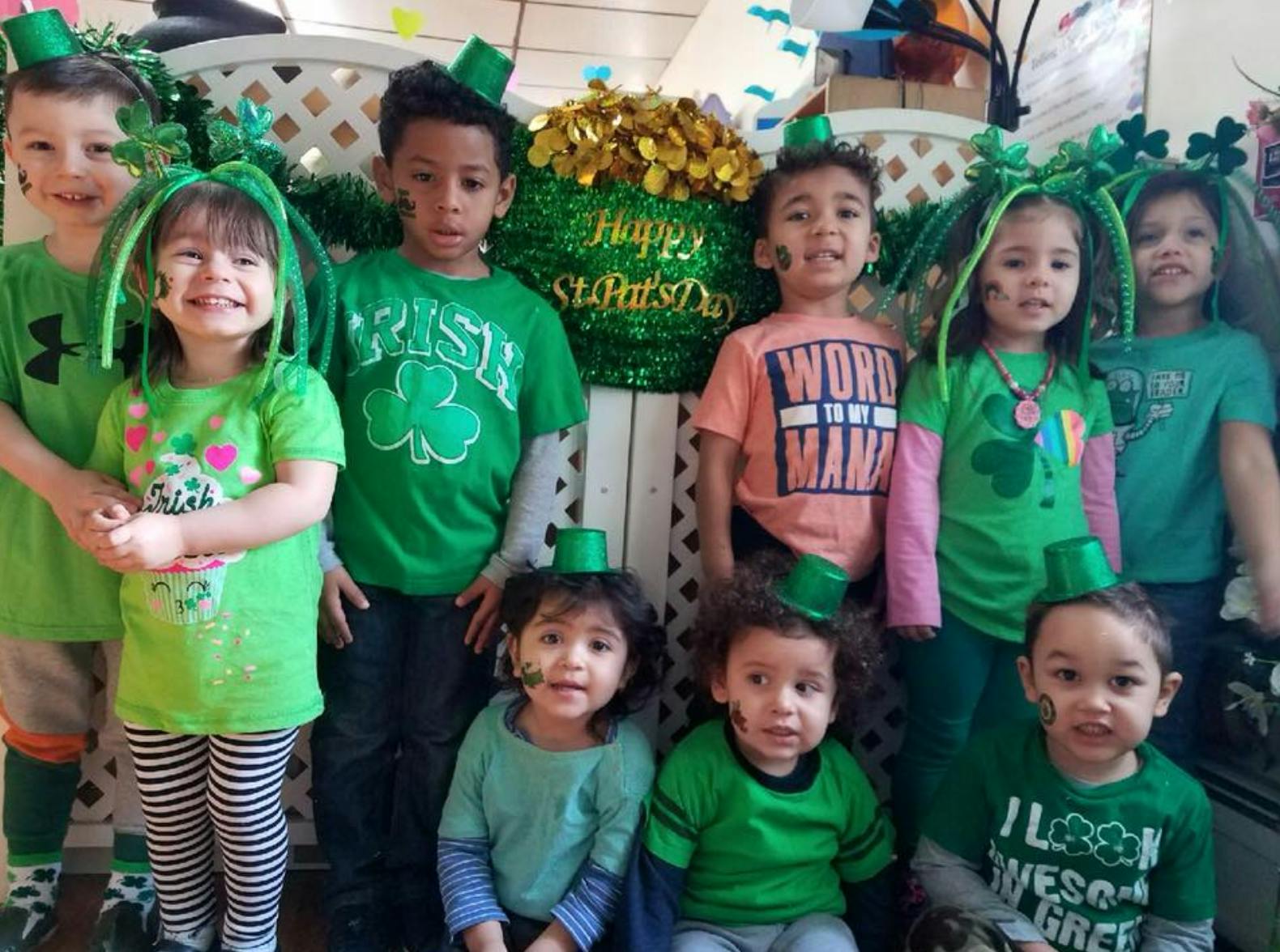 Group of children in green clothing and St. Patrick's Day hats