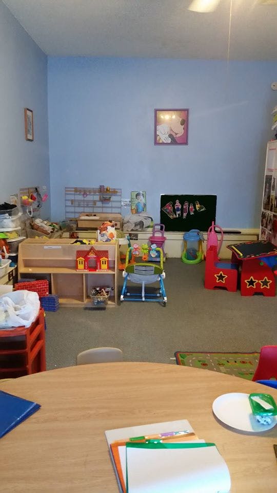 A room with various children's toys and furniture
