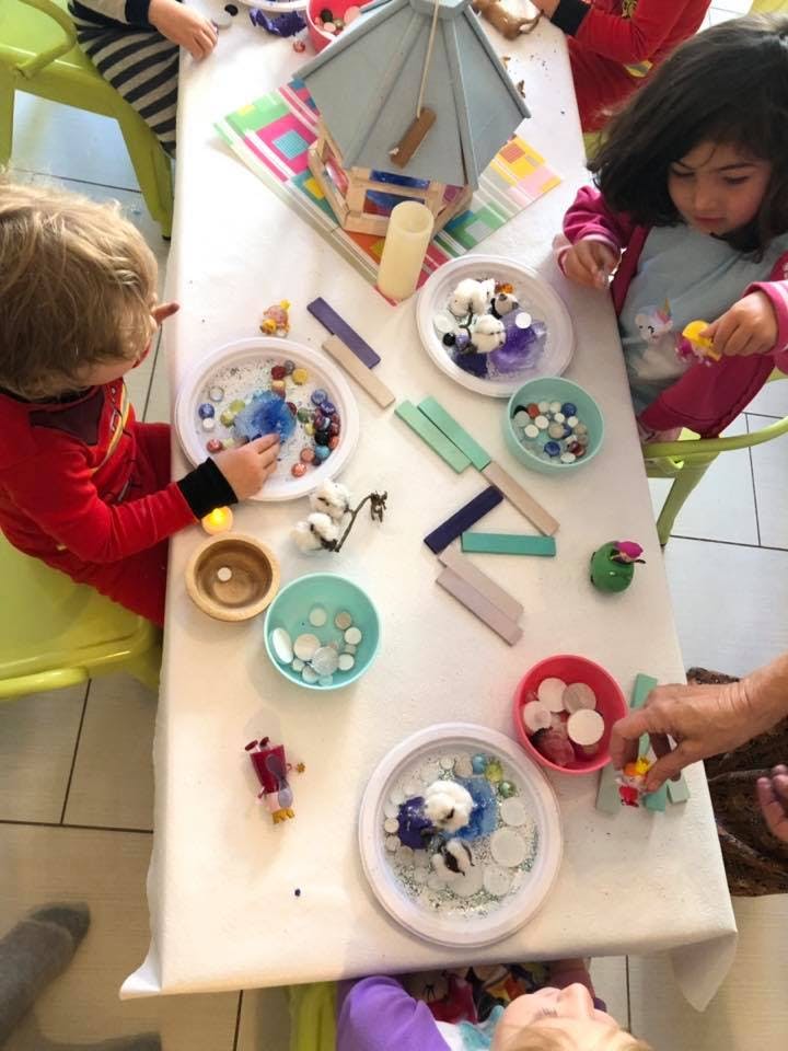 Children at a table with craft supplies