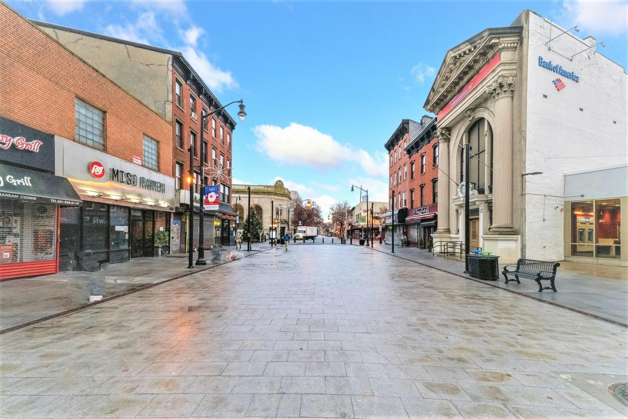 Empty street lined with buildings and storefronts