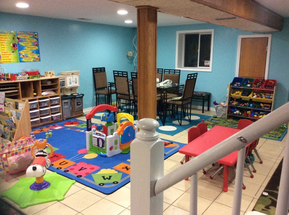 Playroom with toys, small tables, and a dining area
