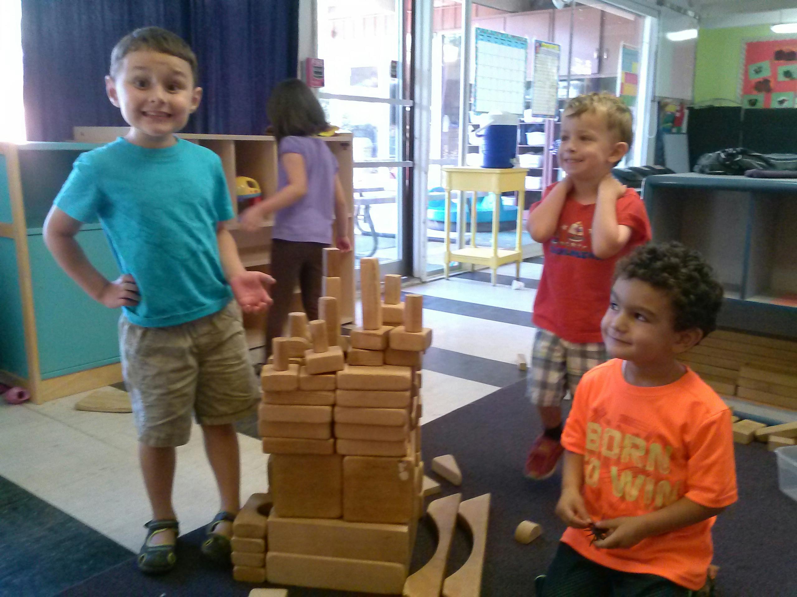 Children playing with wooden blocks in a classroom