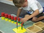 Child playing with colorful stacking blocks