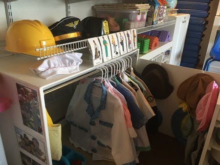 Children's dress-up clothes and hats in a classroom