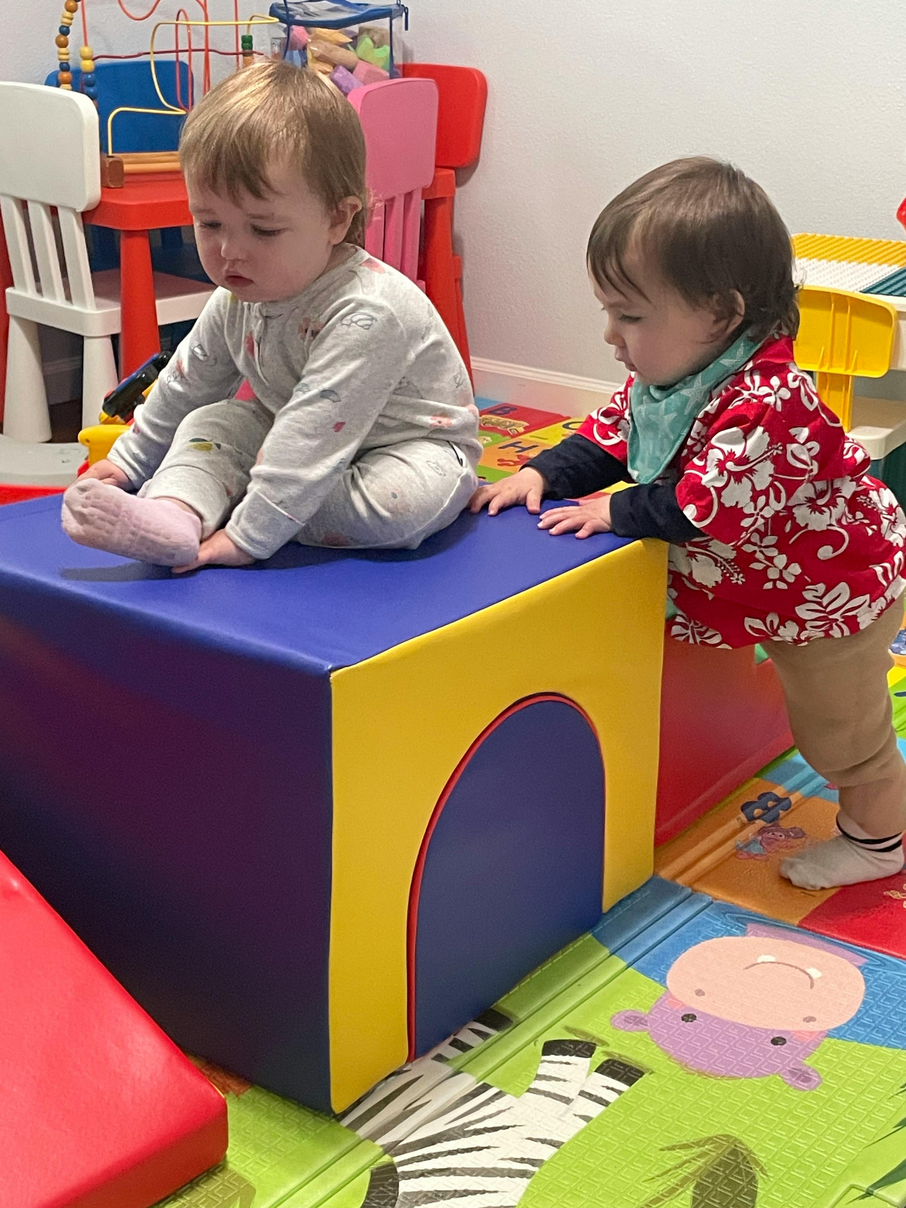 Two children playing with soft blocks