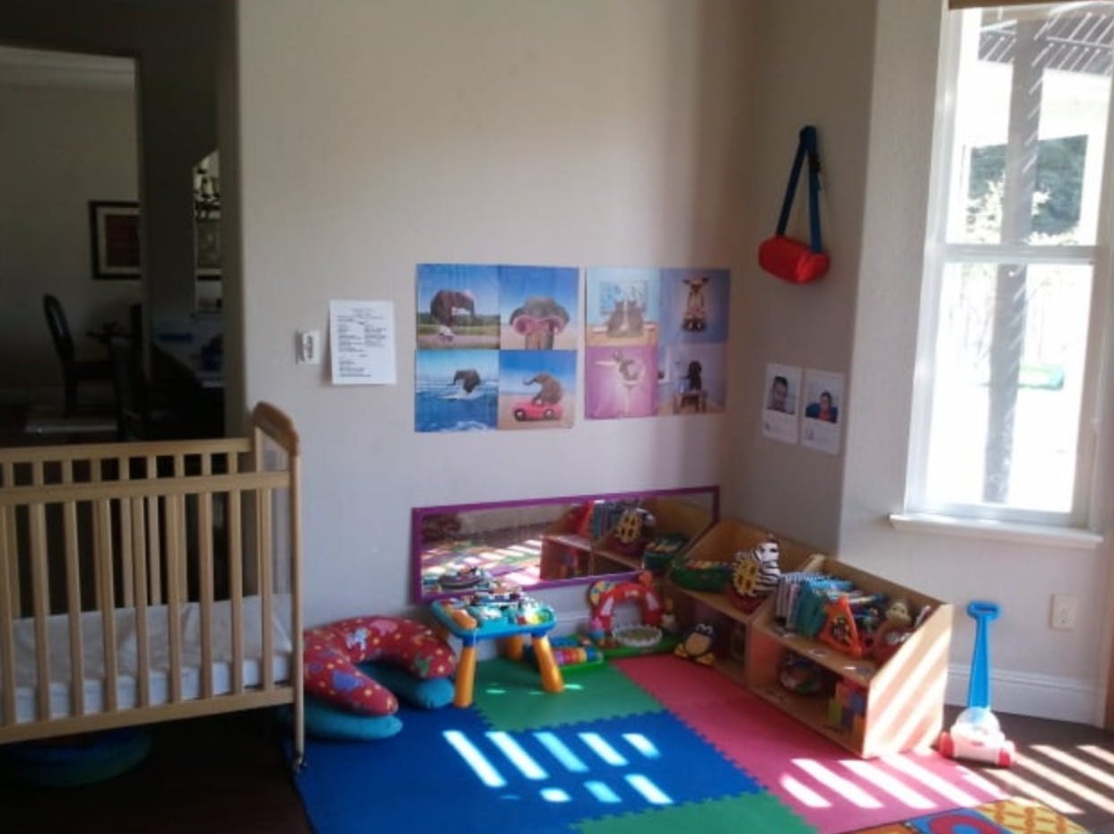 Crib and play area with colorful mat and toys