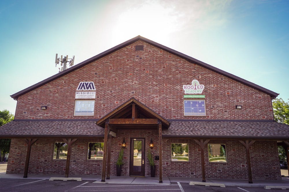 Brick building with a gabled roof and a small covered entrance