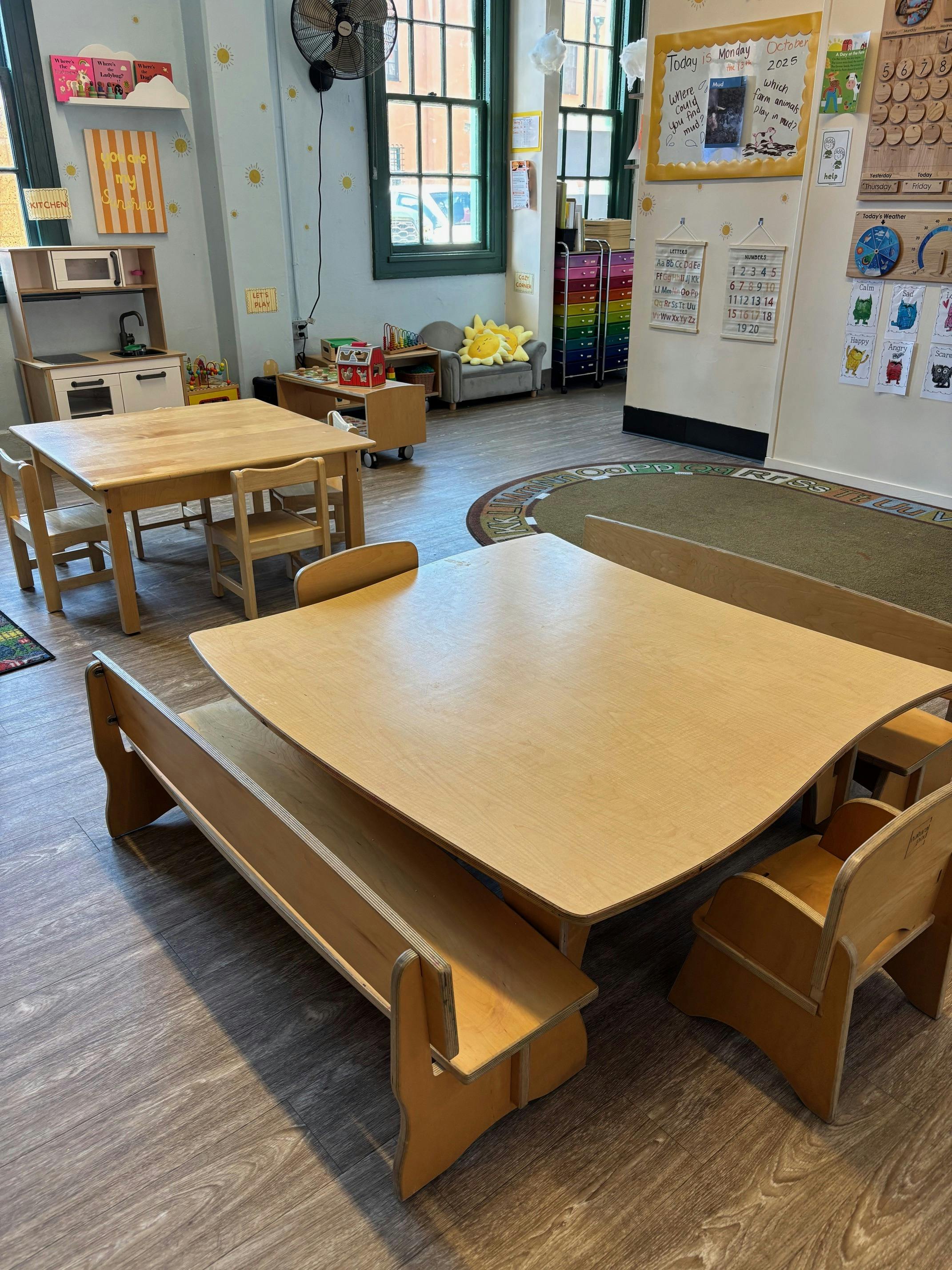 Classroom with small wooden tables and chairs