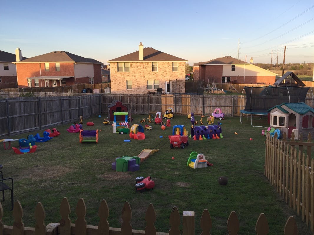 Backyard with various colorful children's play equipment