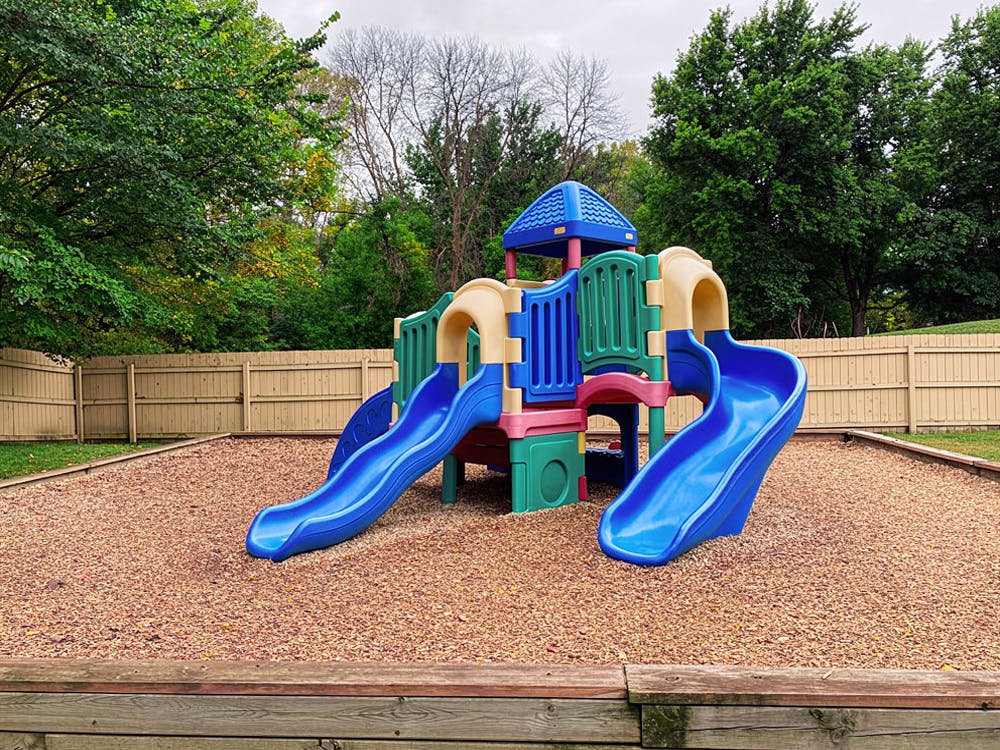 Colorful playground structure with two blue slides