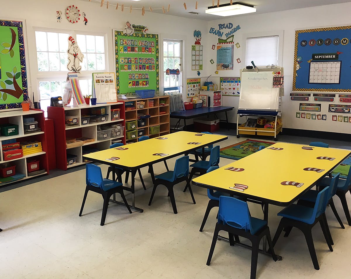 Classroom with yellow tables and blue chairs