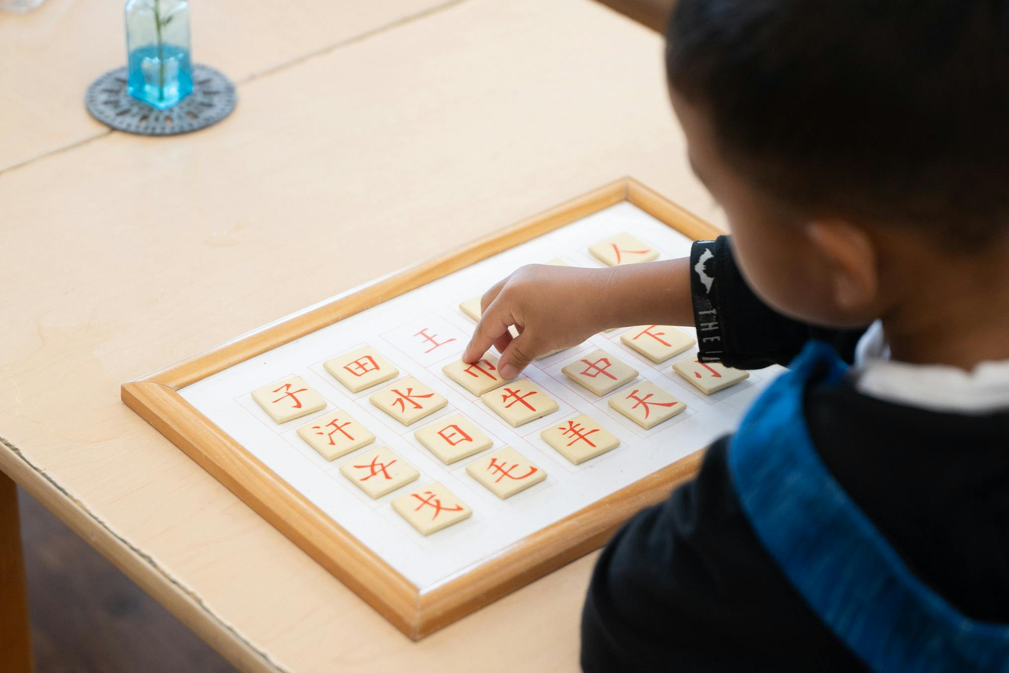 Child placing a tile with a character on a board