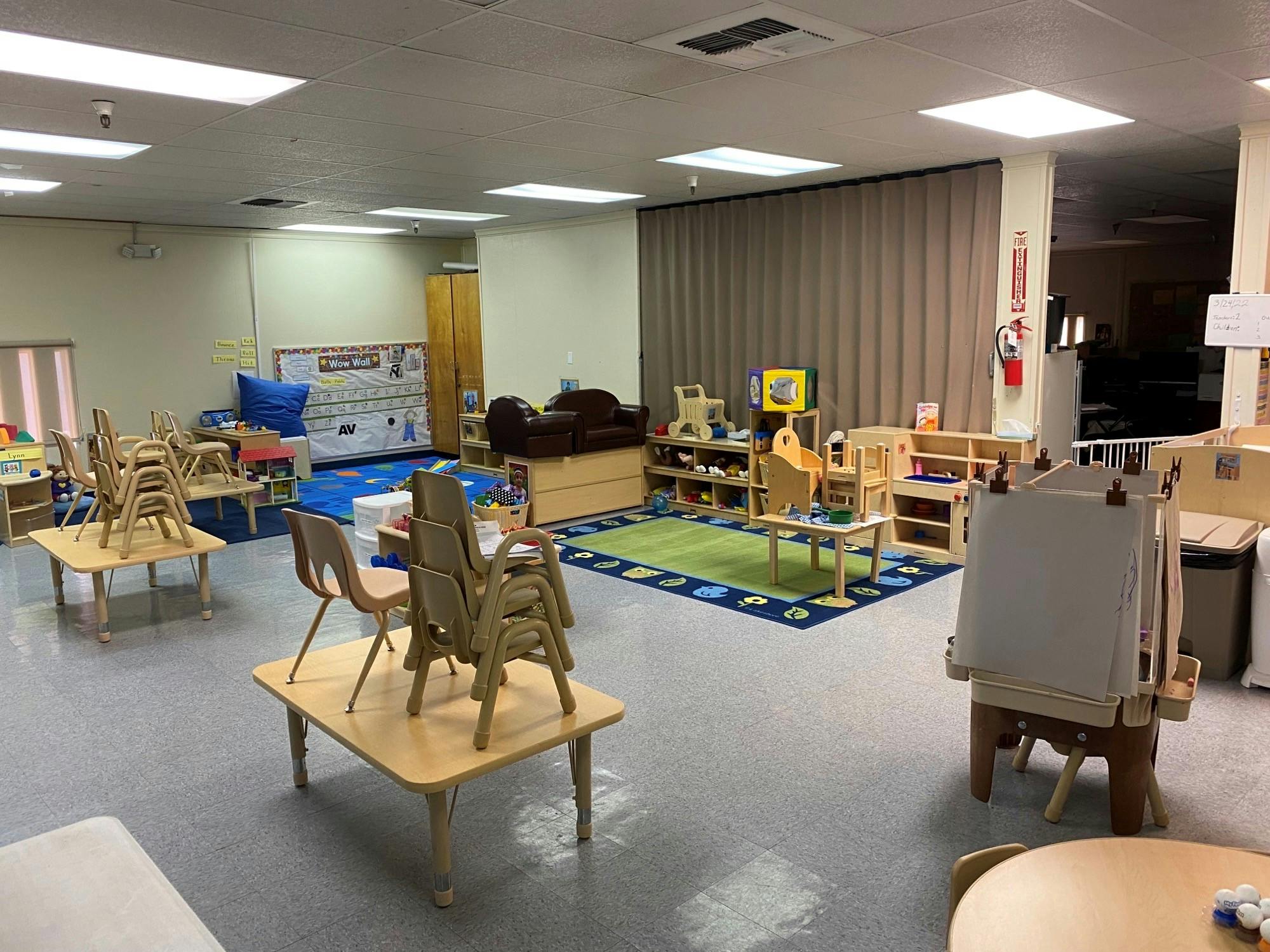 Empty classroom with small tables and chairs