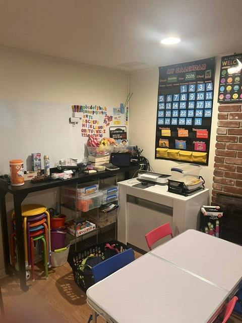 Classroom or home learning area with desks and a calendar wall hanging