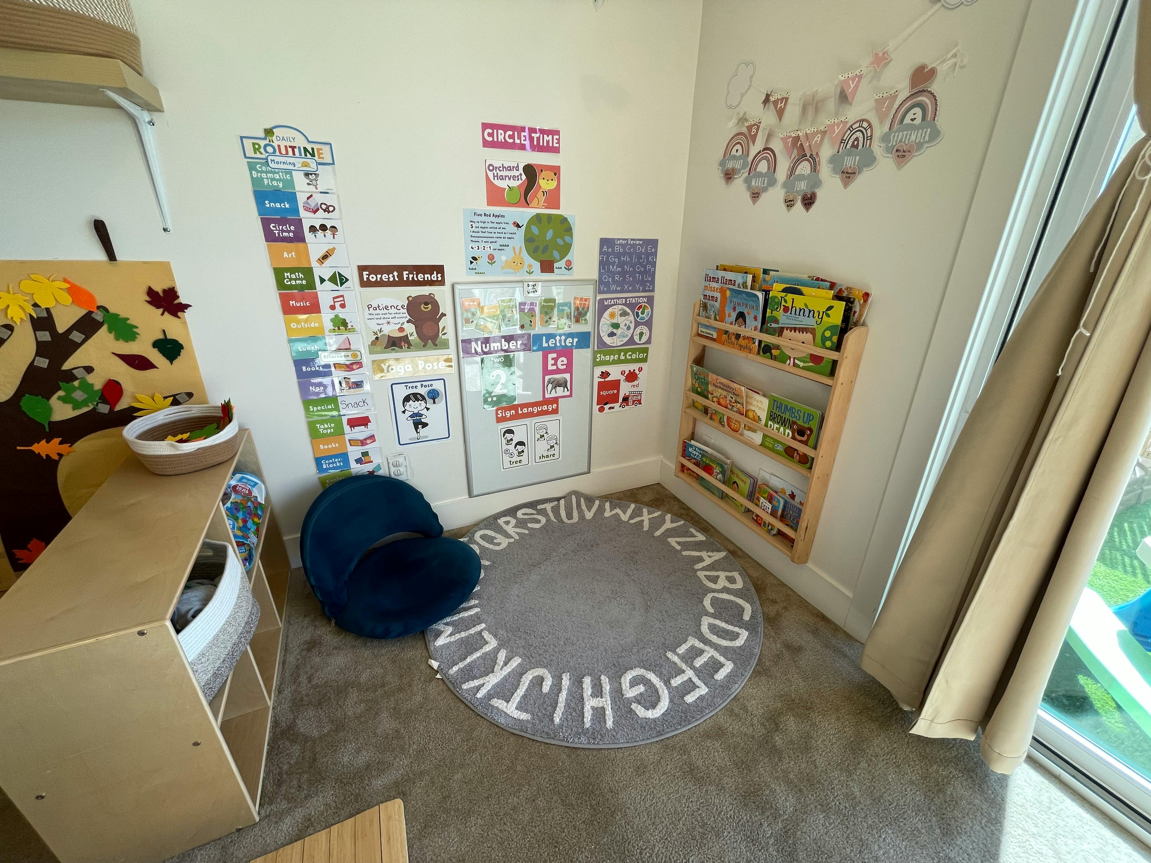 Child's play area with alphabet rug, bookshelf, and wall decorations