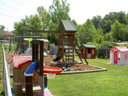 Outdoor playground with swings, slides, and playhouses