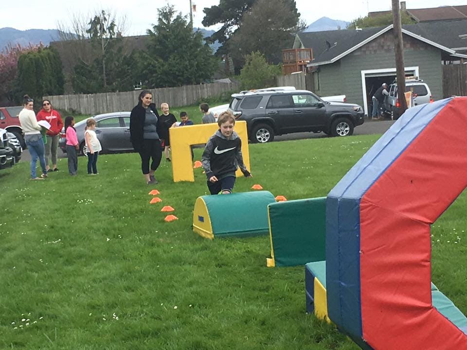 Child running through an outdoor obstacle course