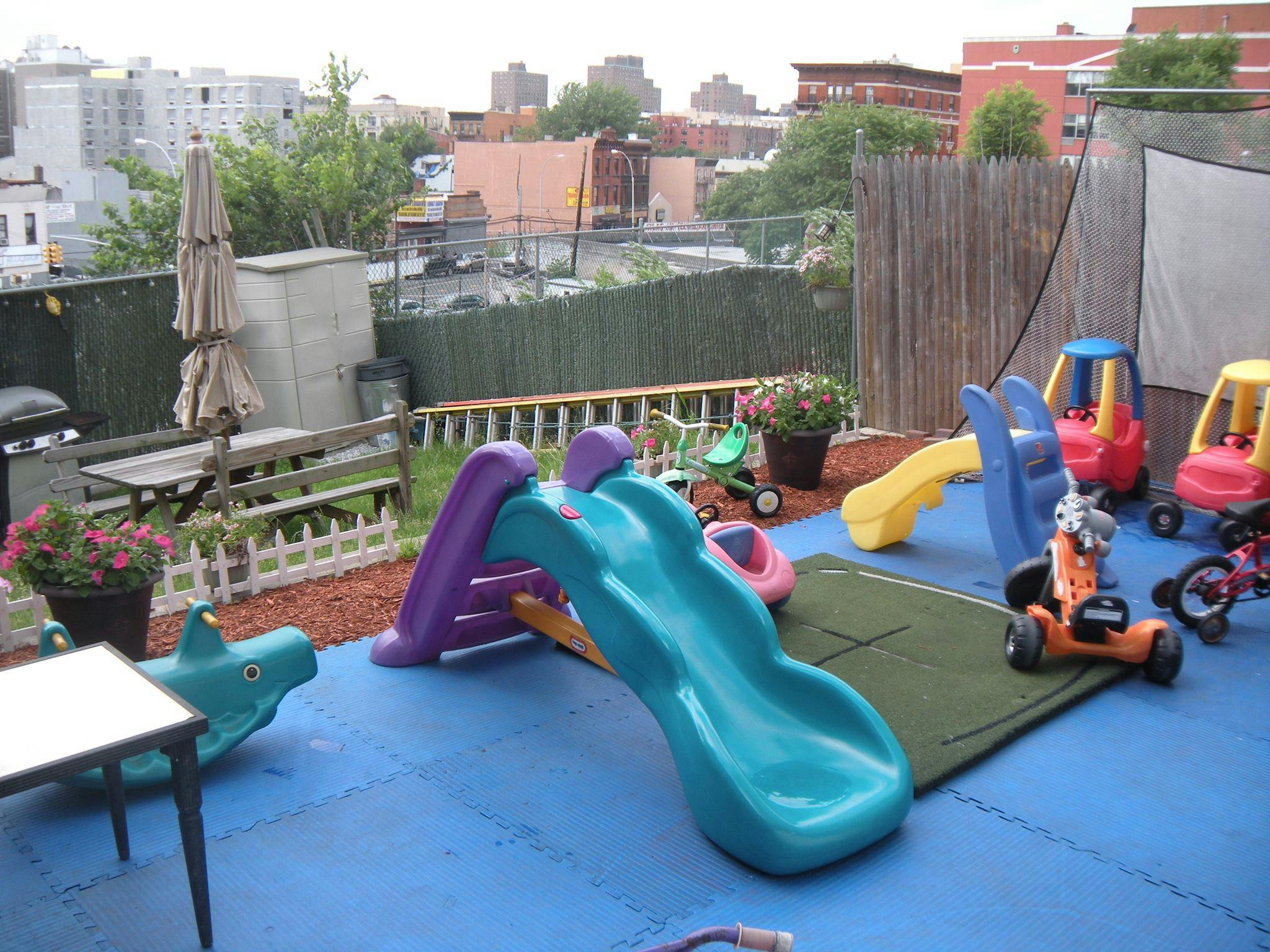 Rooftop playground with slides and ride-on toys