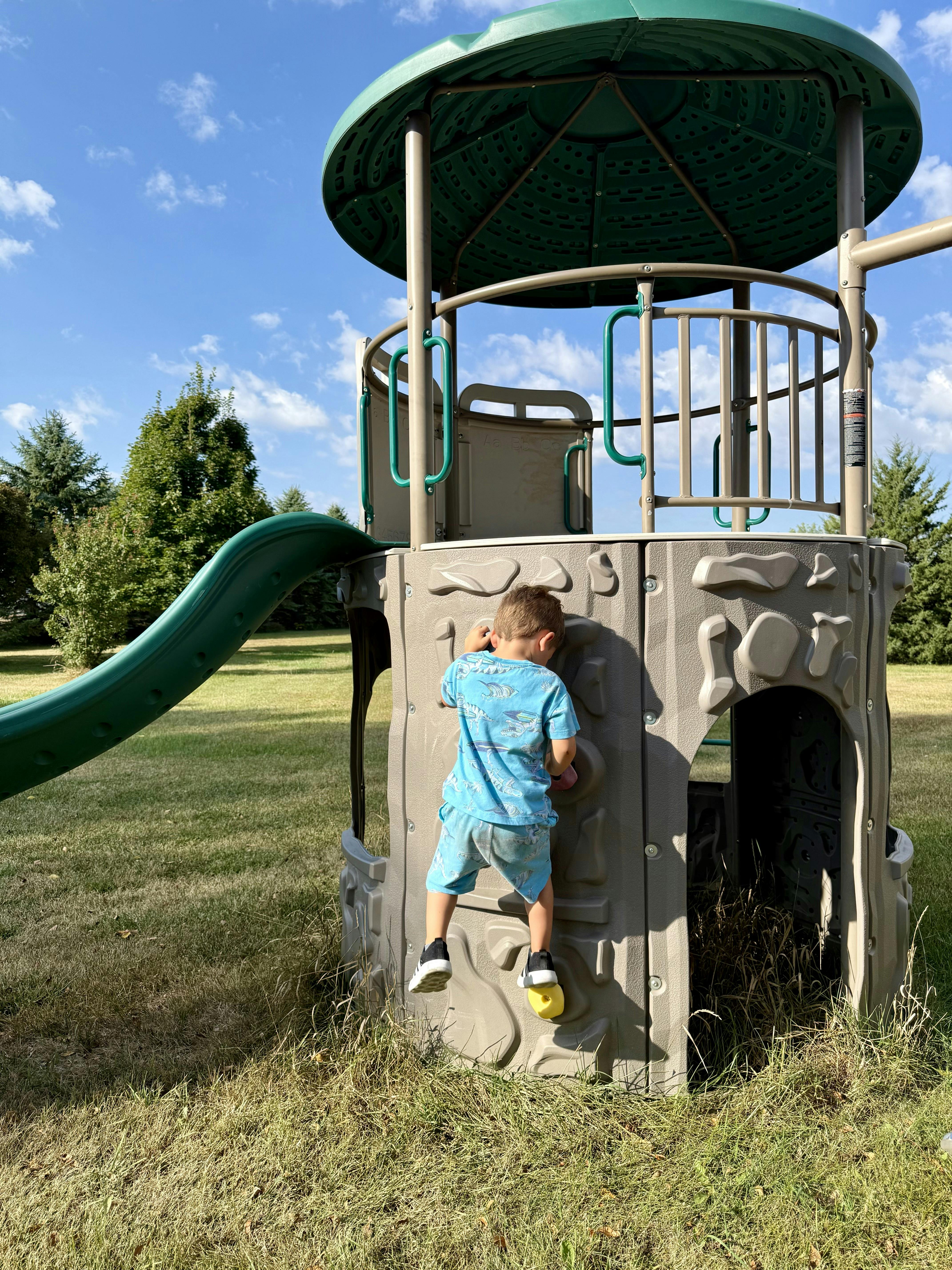 Child climbing a playground structure