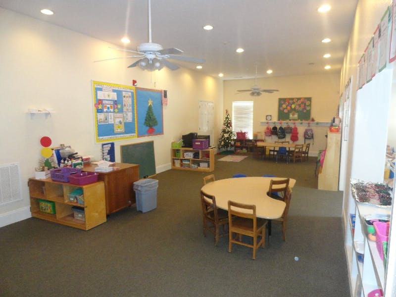 Empty classroom with small tables and chairs