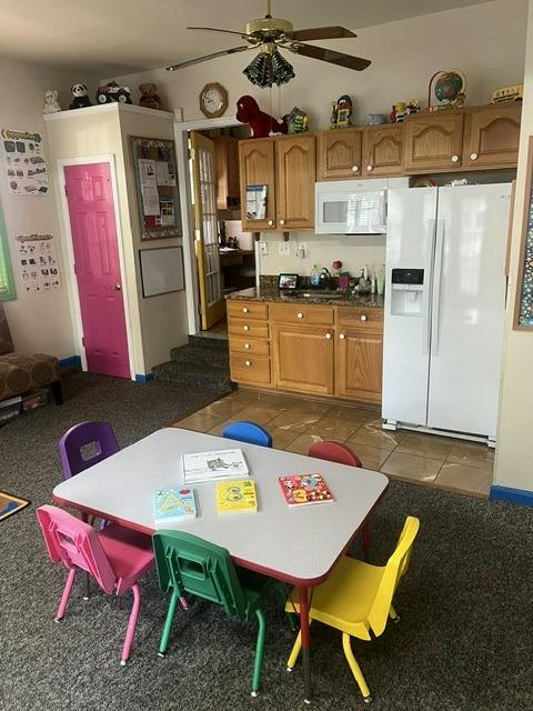 Small table and chairs with children's books in a room