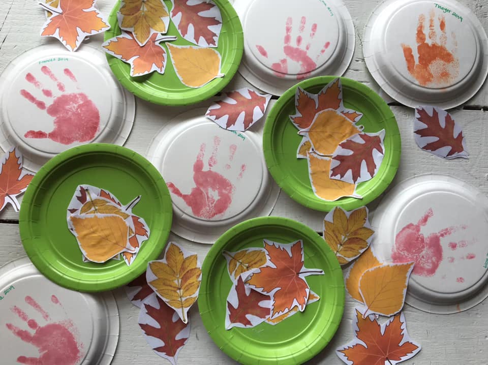 Crafts with paper plates, handprints, and paper leaves