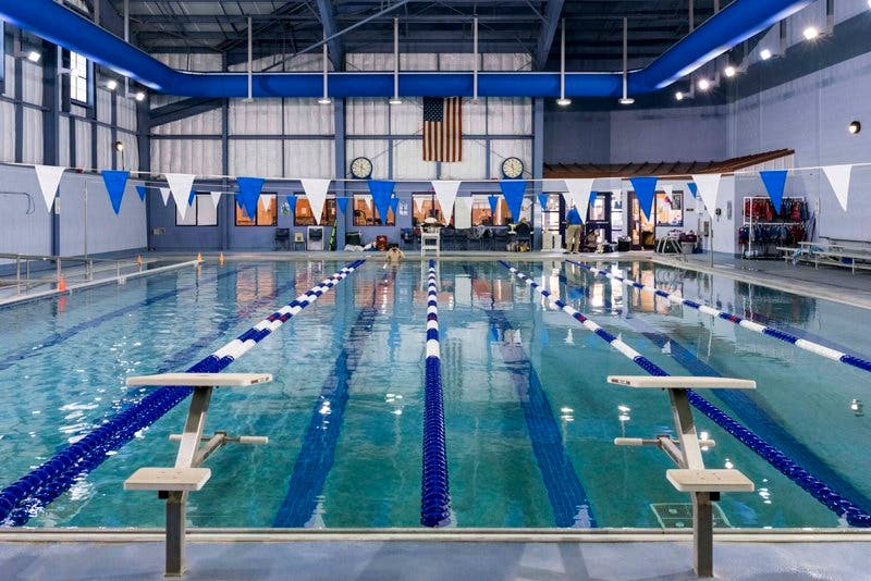 Indoor swimming pool with blue lane lines and starting blocks