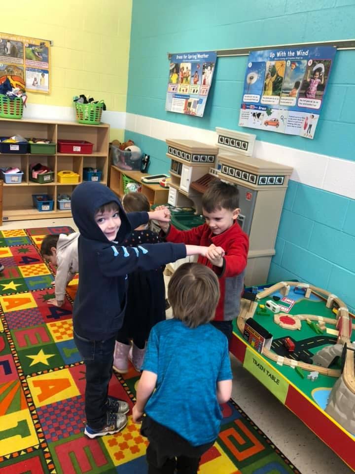 Children playing together in a classroom