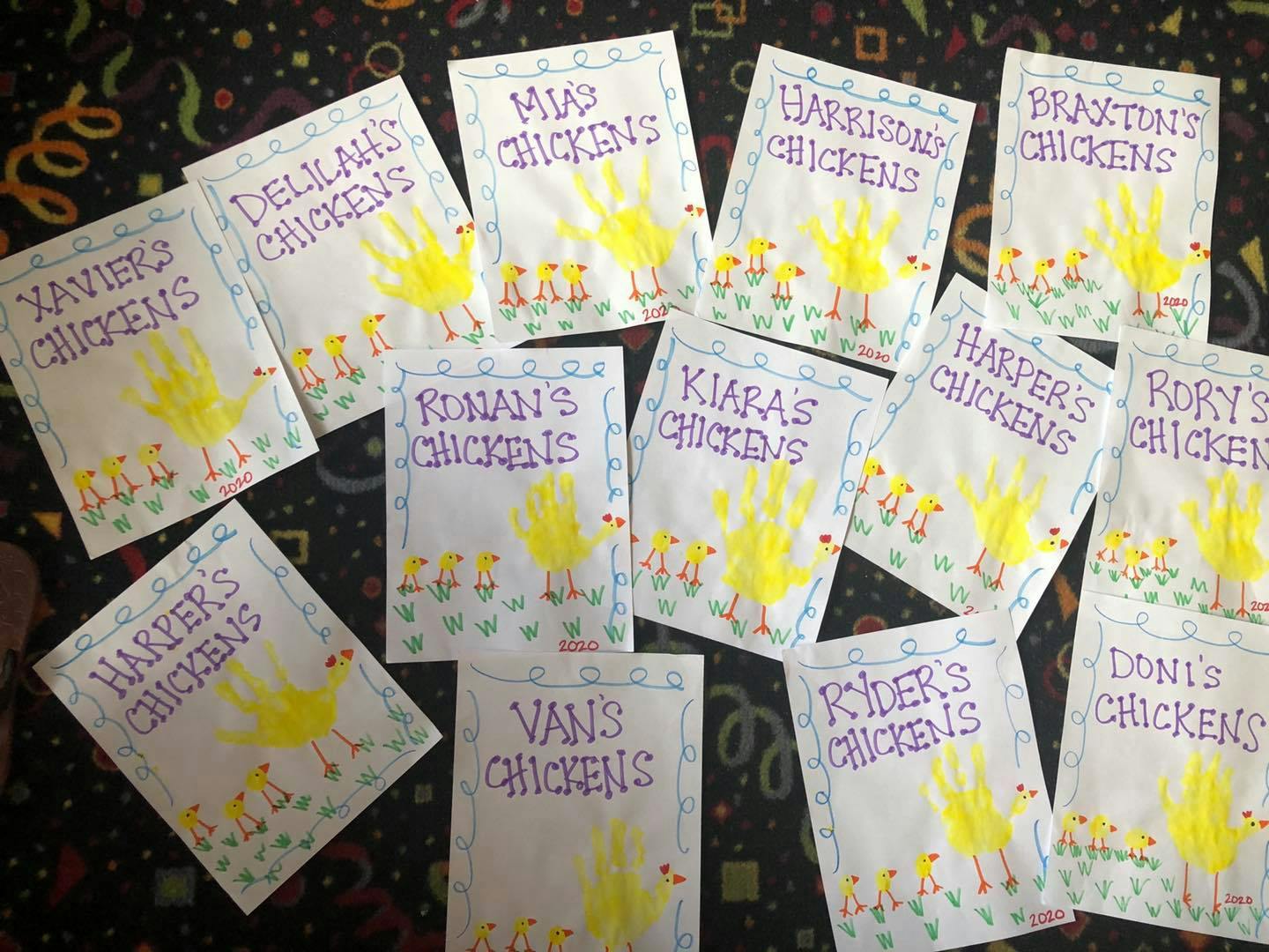 Multiple children's handprint chicken crafts with names