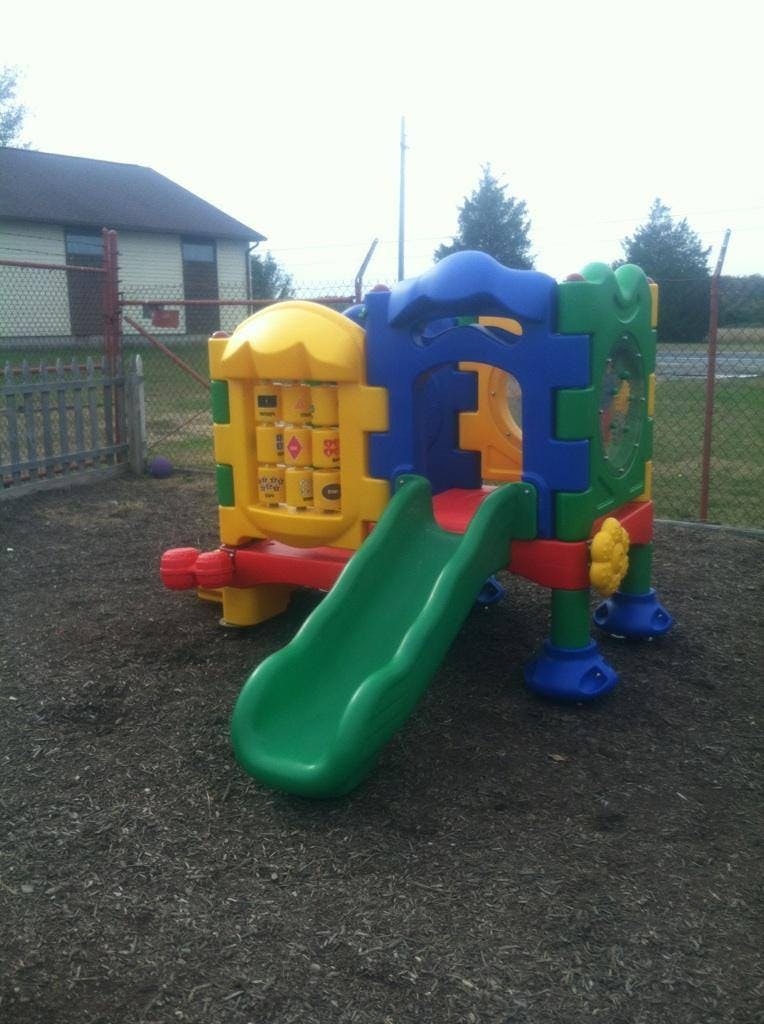 Colorful playground structure with a green slide