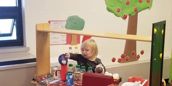 Child playing with toys at a table