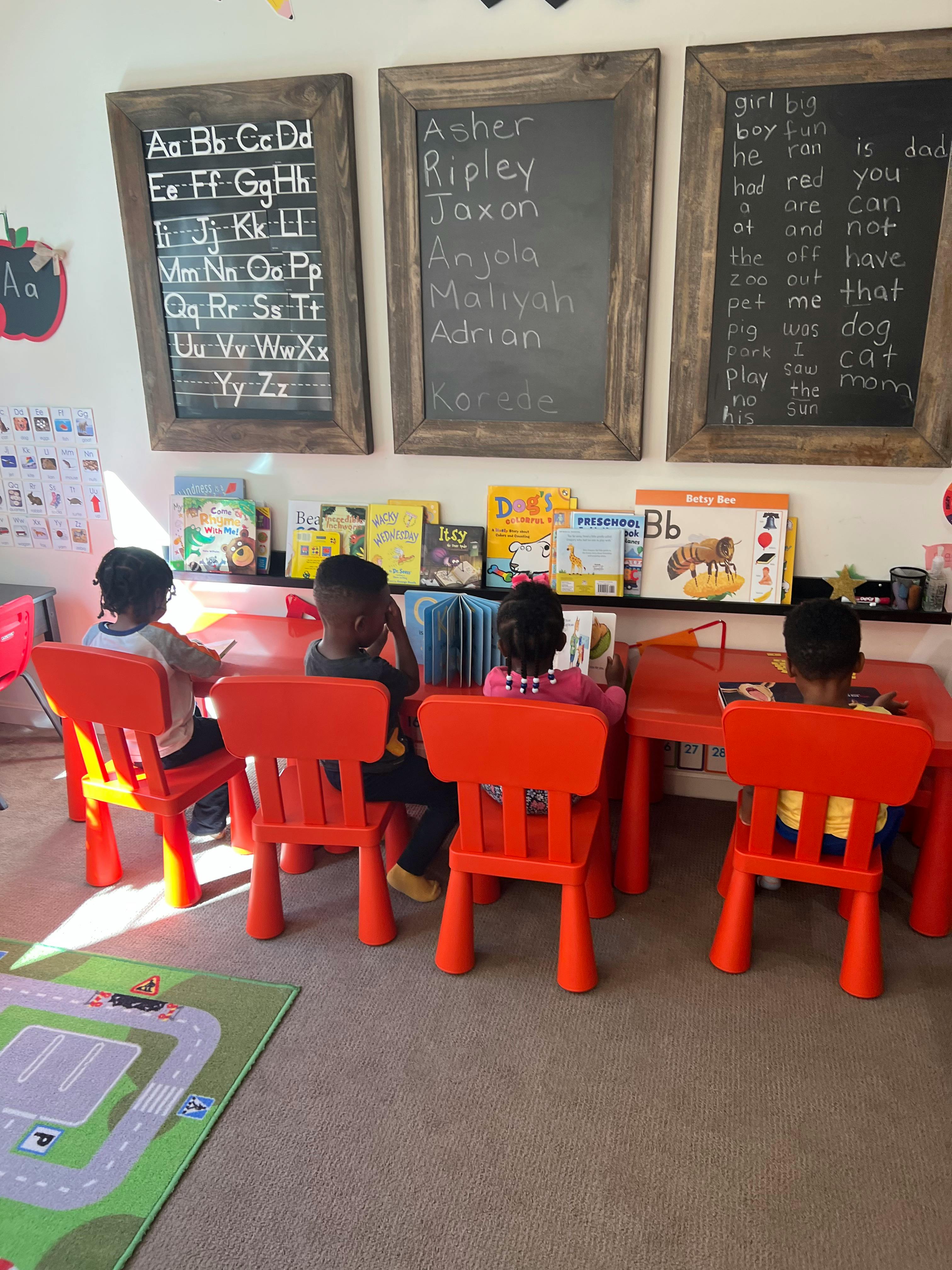 Children sitting at small tables in a classroom